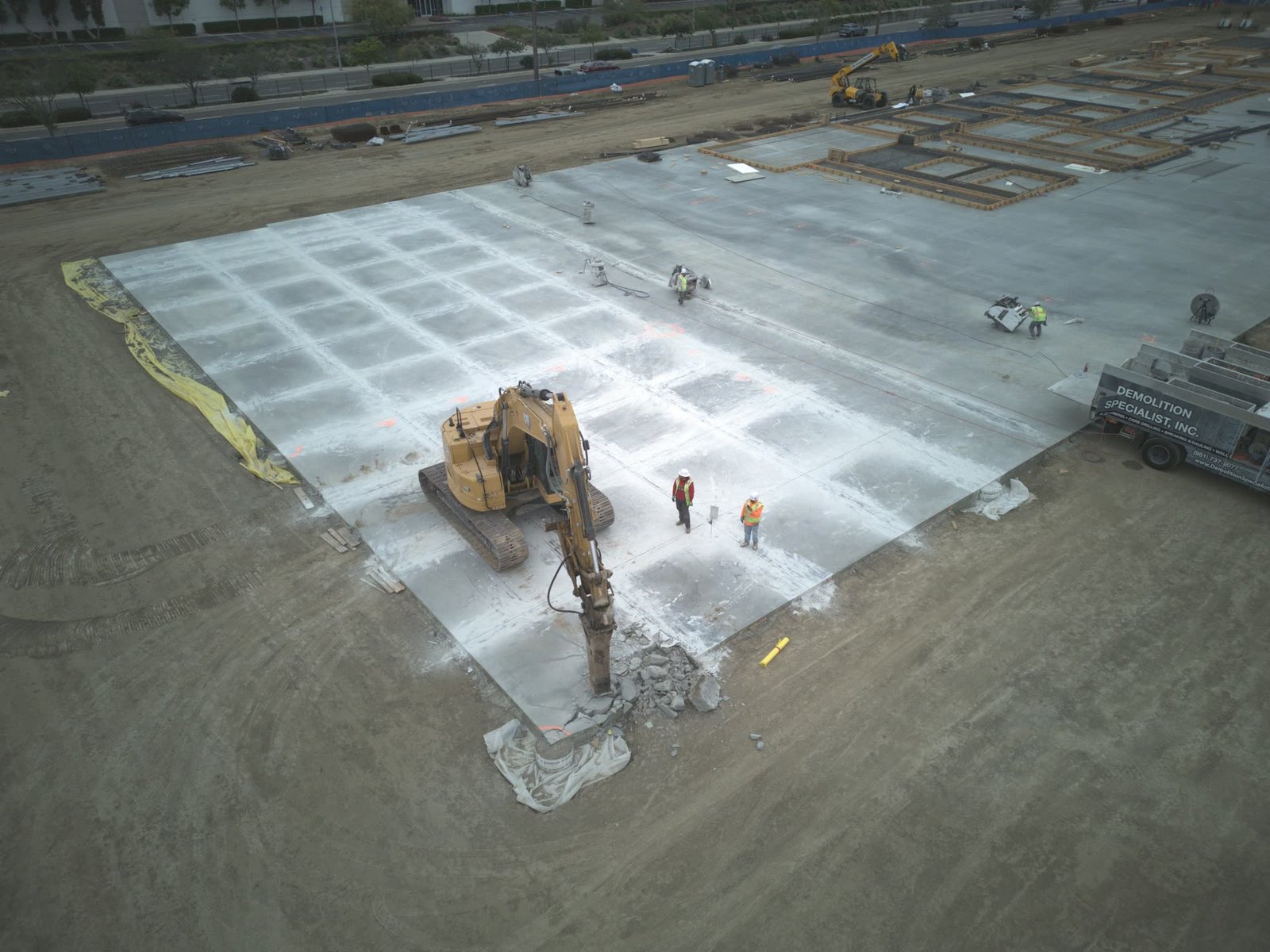 Aerial view of hydraulic breaker demolishing concrete panels