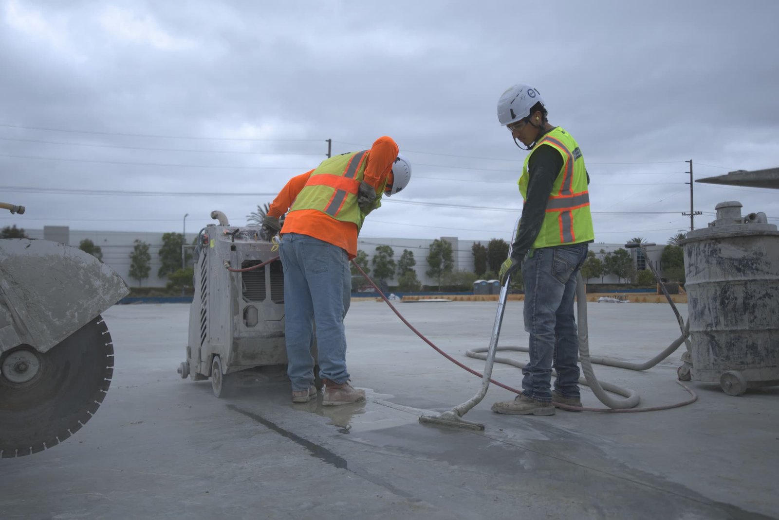DSI crew flat sawing concrete slab with water management