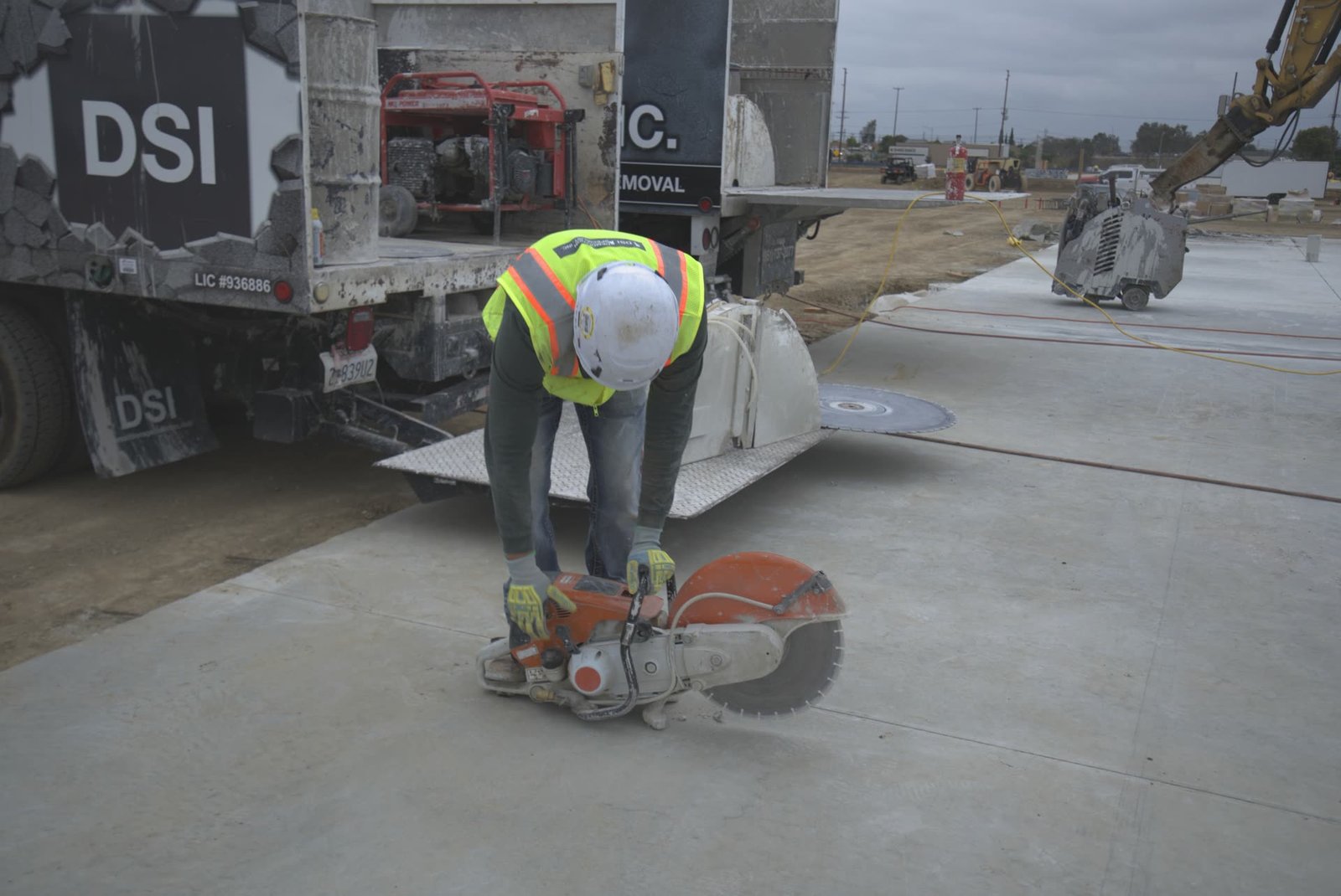 Husqvarna hand saw concrete cutting next to DSI service truck